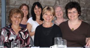 six USW members standing behind a table